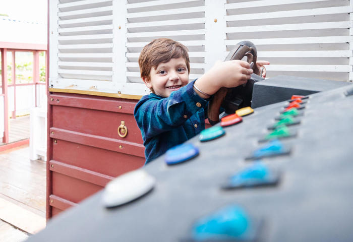 Boy Using A Steering Wheel At Cubby Cafe